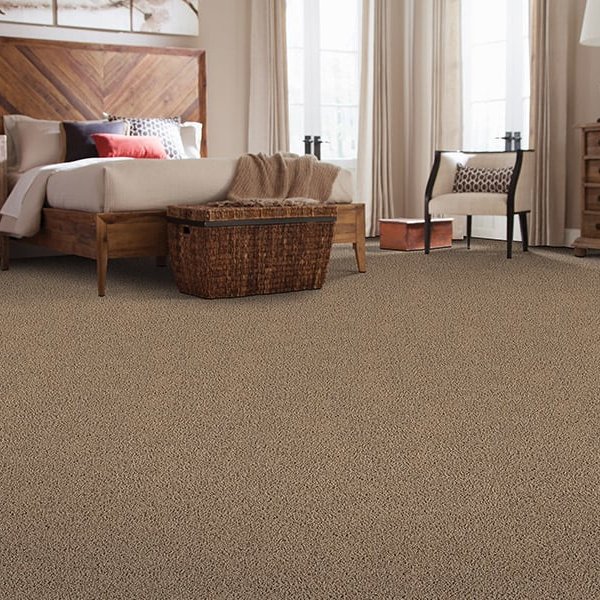 Bedroom with brown Smartstrand carpeting in Dayton, OH by Bockrath Flooring and Rugs
