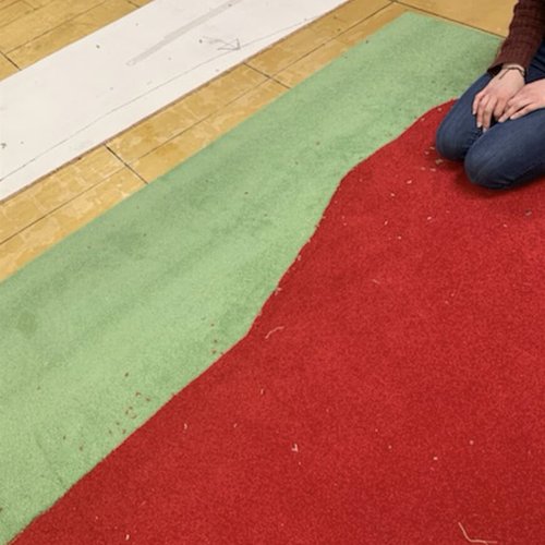 Cutting custom rug design in Dayton OH by Bockrath Flooring & Rugs