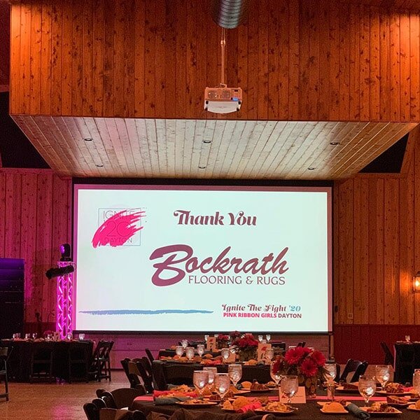 Thank you Bockrath Flooring & Rugs sign at a Pink Ribbon Girls event
