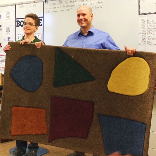Custom area rug contest winner with Bockrath Flooring team