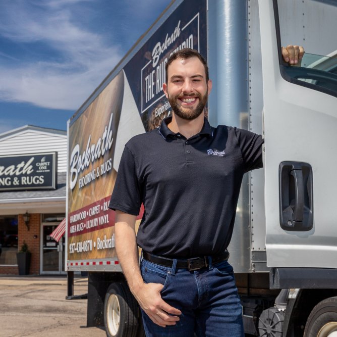 Bockrath Rug Studio team member standing next to a delivery truck